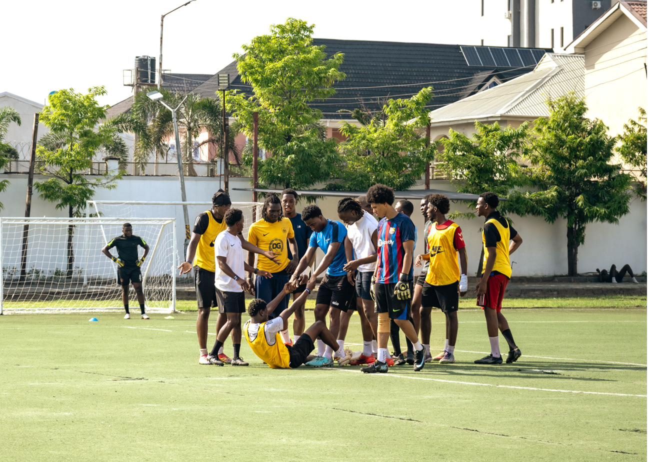 A player helping a team-mate up